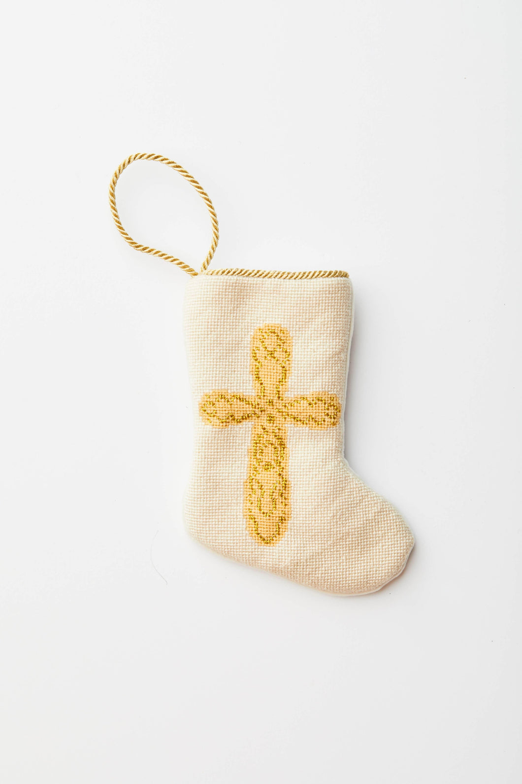 Needlepoint stocking with golden cross on ivory background
