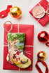 Bauble Stockings styled with gold ornaments, red gift wrap, and festive holiday decor