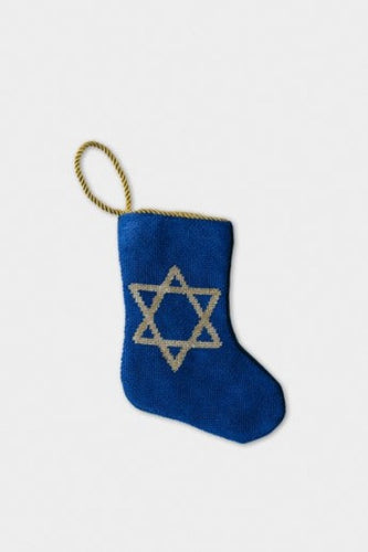 Hand-stitched needlepoint stocking with embroidered star on deep blue background