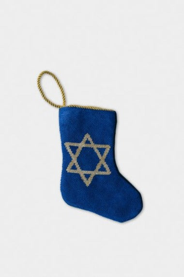 Hand-stitched needlepoint stocking with embroidered star on deep blue background