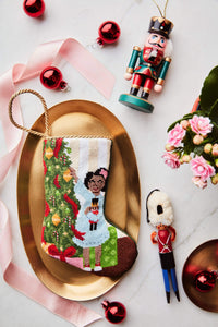 Bauble Stockings styled on gold tray with festive red ornaments, and nutcracker figurine