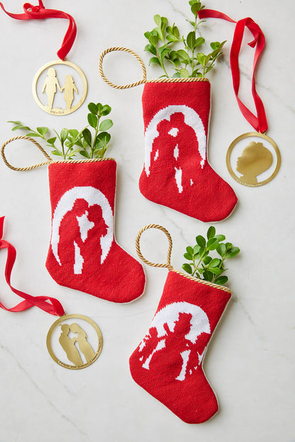 Together Forever needlepoint stockings styled with greenery and gold silhouette ornaments