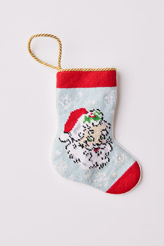 Hand-stitched Christmas stocking featuring a vintage Santa with a red hat and green accents on a light blue background