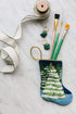 Bauble Stockings with paintbrushes on marble background for a wintry setting