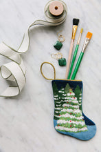Bauble Stockings with paintbrushes on marble background for a wintry setting