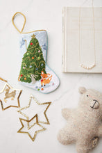 Bauble Stockings styled with plush toy bear and star-shaped decor
